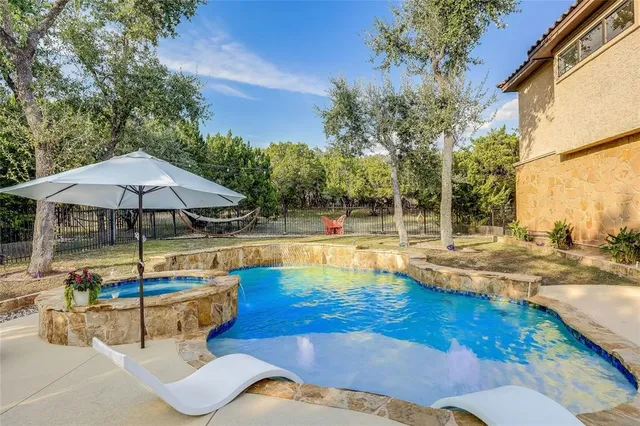 a view of a swimming pool with an outdoor seating