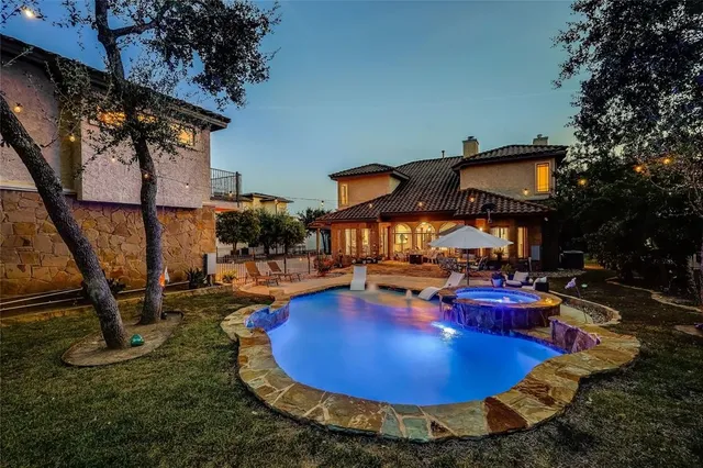 an aerial view of a swimming pool with table and chairs