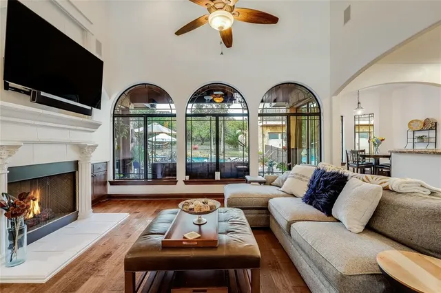 a living room with furniture chandelier and a flat screen tv