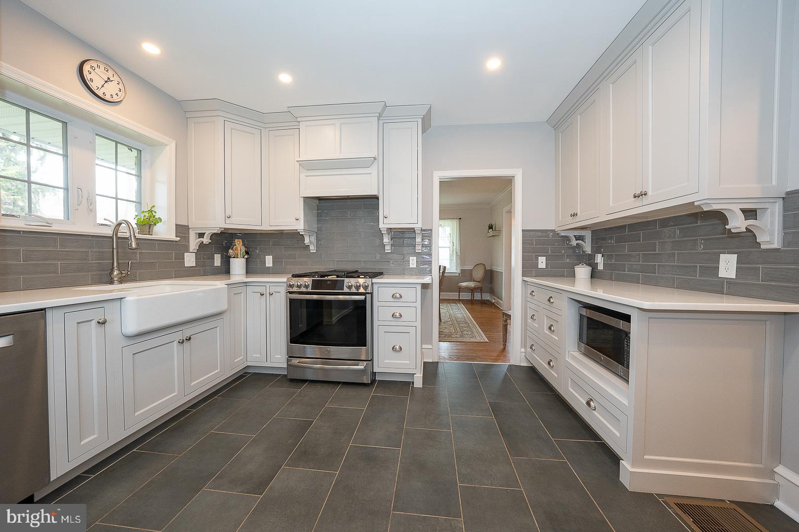 361 Summit Road Springfield, PA 19064 - Photo 12 of 42 a kitchen with a white cabinets and white appliances