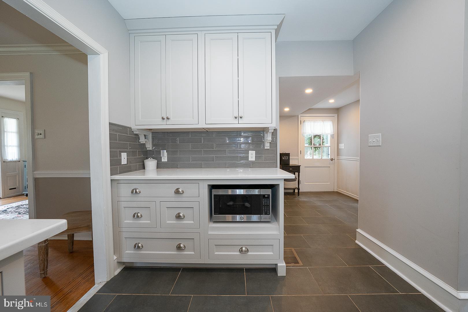 361 Summit Road Springfield, PA 19064 - Photo 13 of 42 a kitchen with granite countertop white cabinets and white appliances