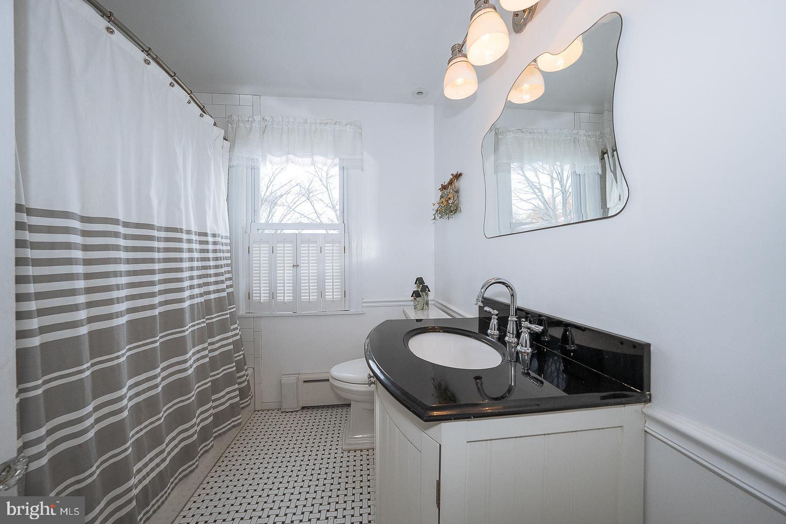 361 Summit Road Springfield, PA 19064 - Photo 31 of 42 a bathroom with a sink a vanity and a mirror