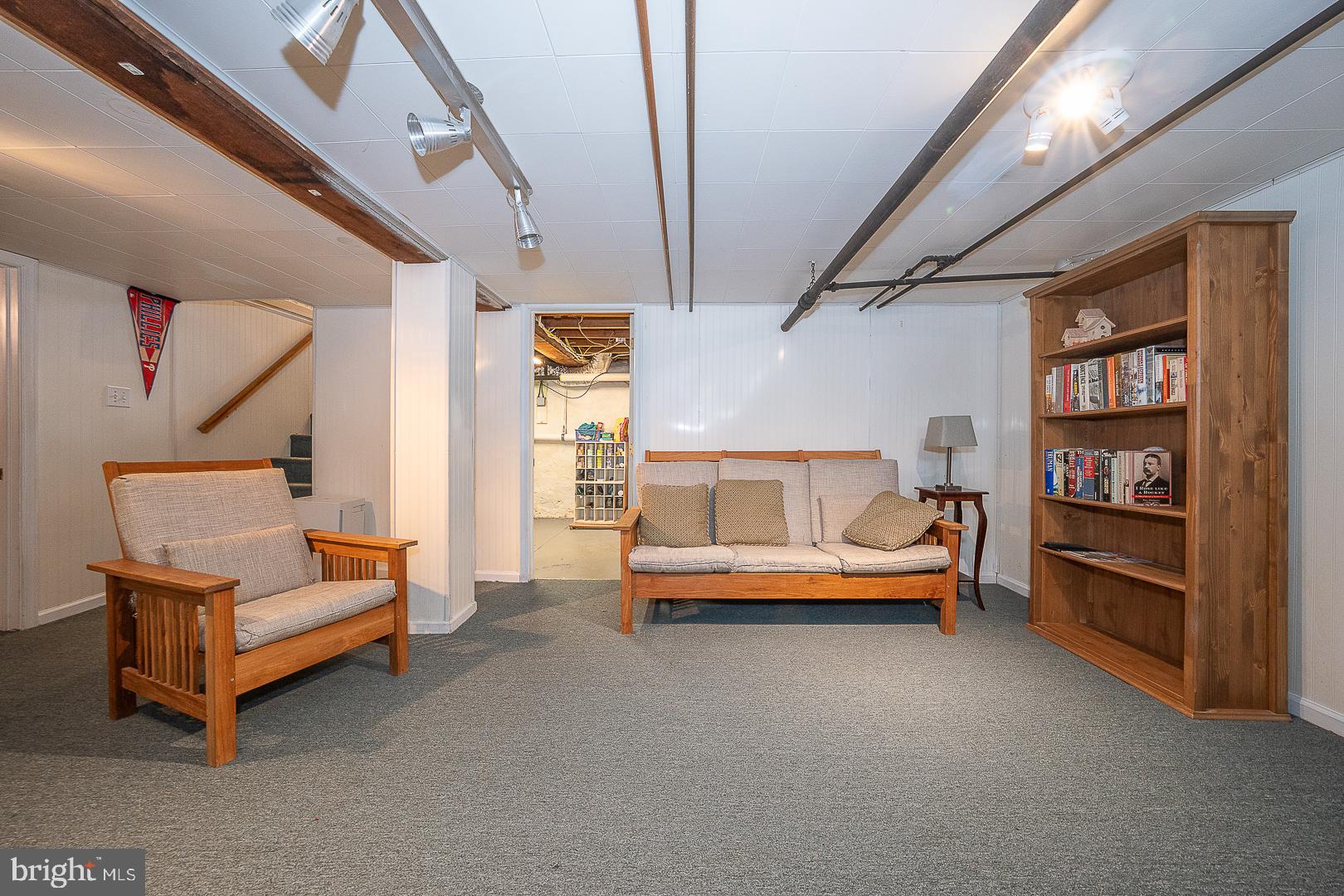 361 Summit Road Springfield, PA 19064 - Photo 36 of 42 a living room with furniture and a book shelf