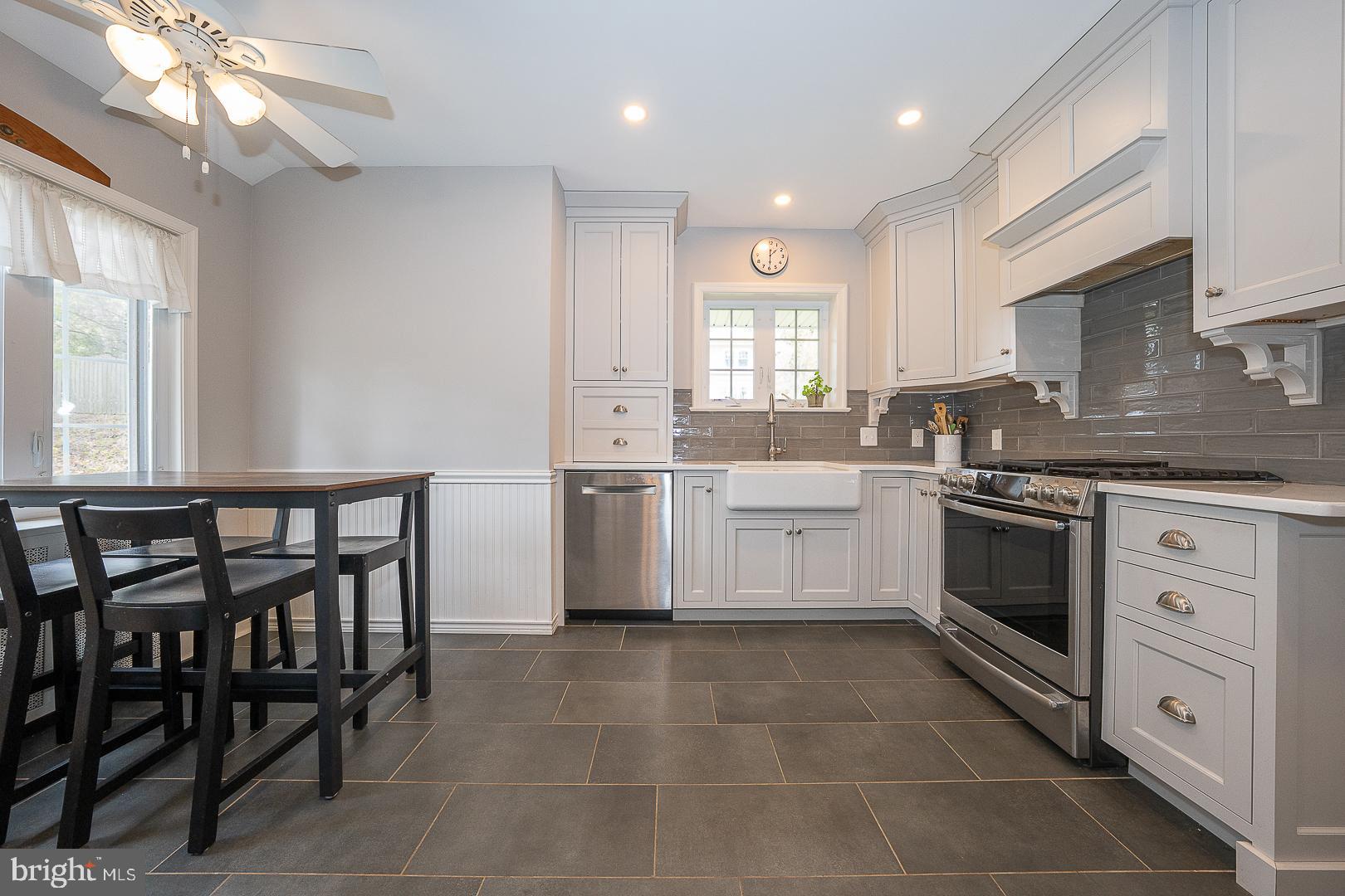 361 Summit Road Springfield, PA 19064 - Photo 9 of 42 a kitchen with a stove a sink and a refrigerator