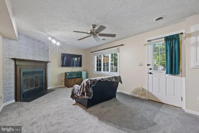 a living room with furniture and a fireplace