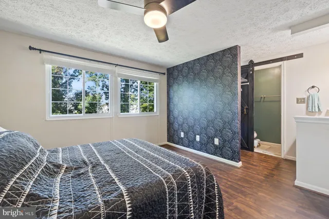 a bedroom with a large bed and a window