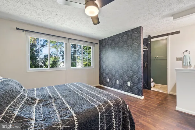 a bedroom with a large bed and a window