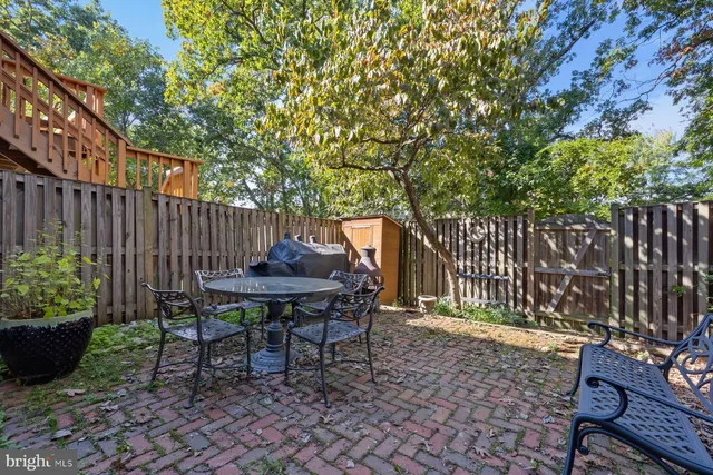 a view of a bench in the backyard
