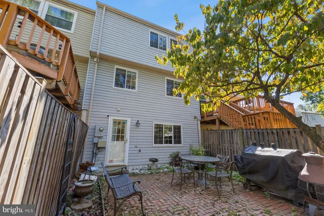 a backyard of a house with outdoor seating