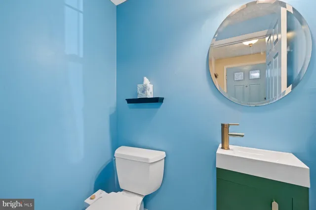 a bathroom with a toilet a sink and mirror