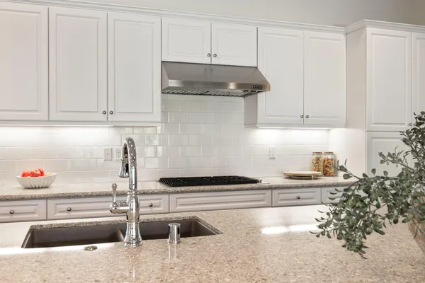 a kitchen with a sink and cabinets