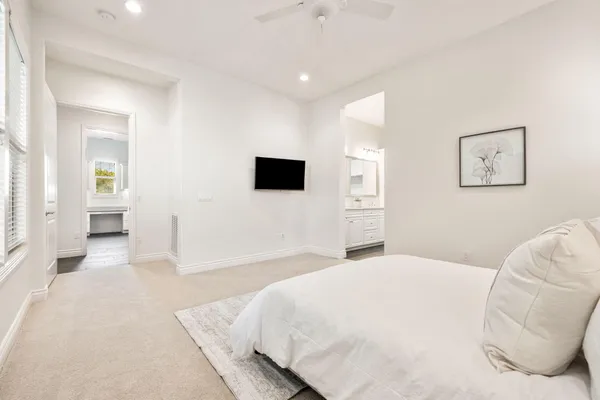 a spacious bathroom with a double vanity sink and mirror