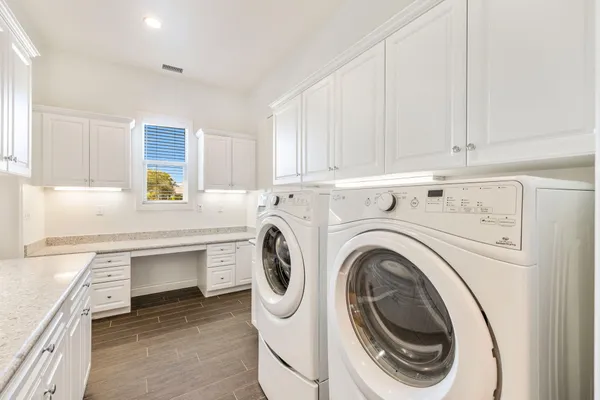 a kitchen with granite countertop white cabinets and white appliances