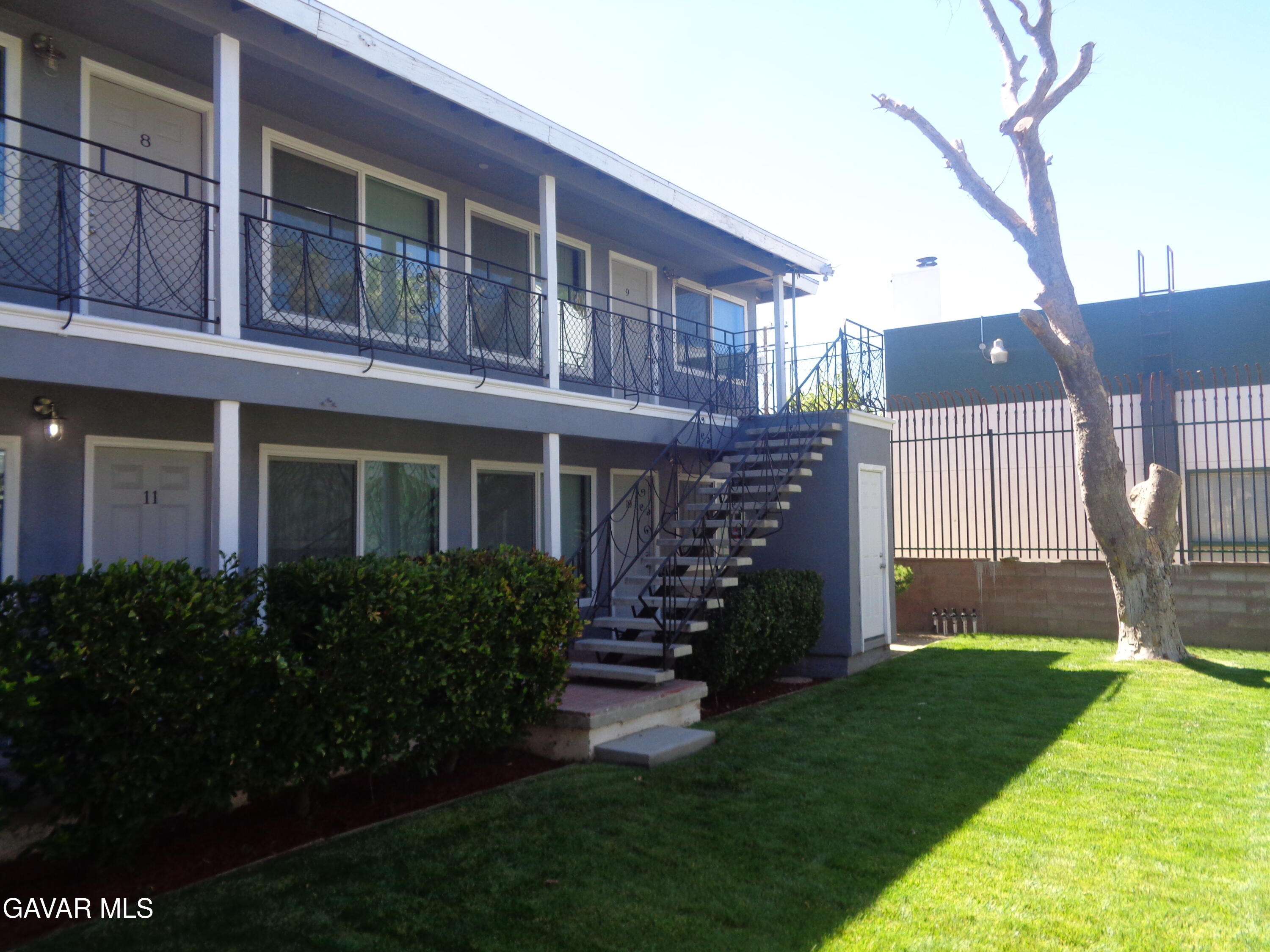 a view of house with a yard and plants