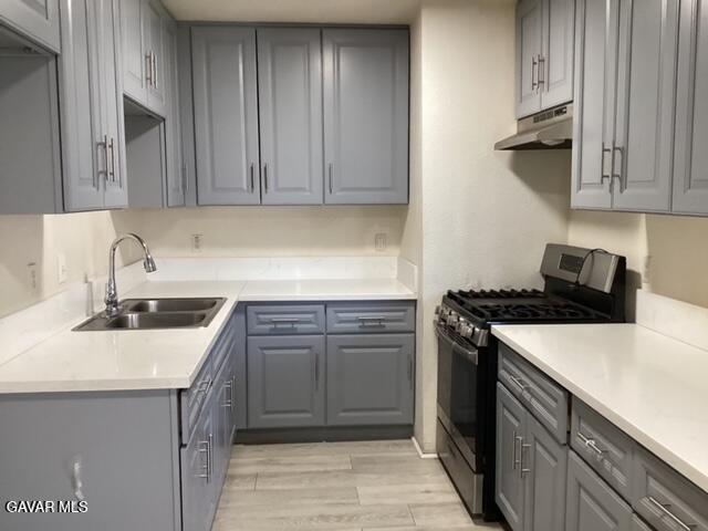 44254 Beech Avenue, Unit 8 Lancaster, CA 93534 - Photo 3 of 5 a kitchen with stainless steel appliances granite countertop a sink stove and refrigerator