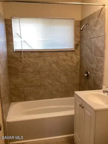 a bathroom with a bathtub and shower