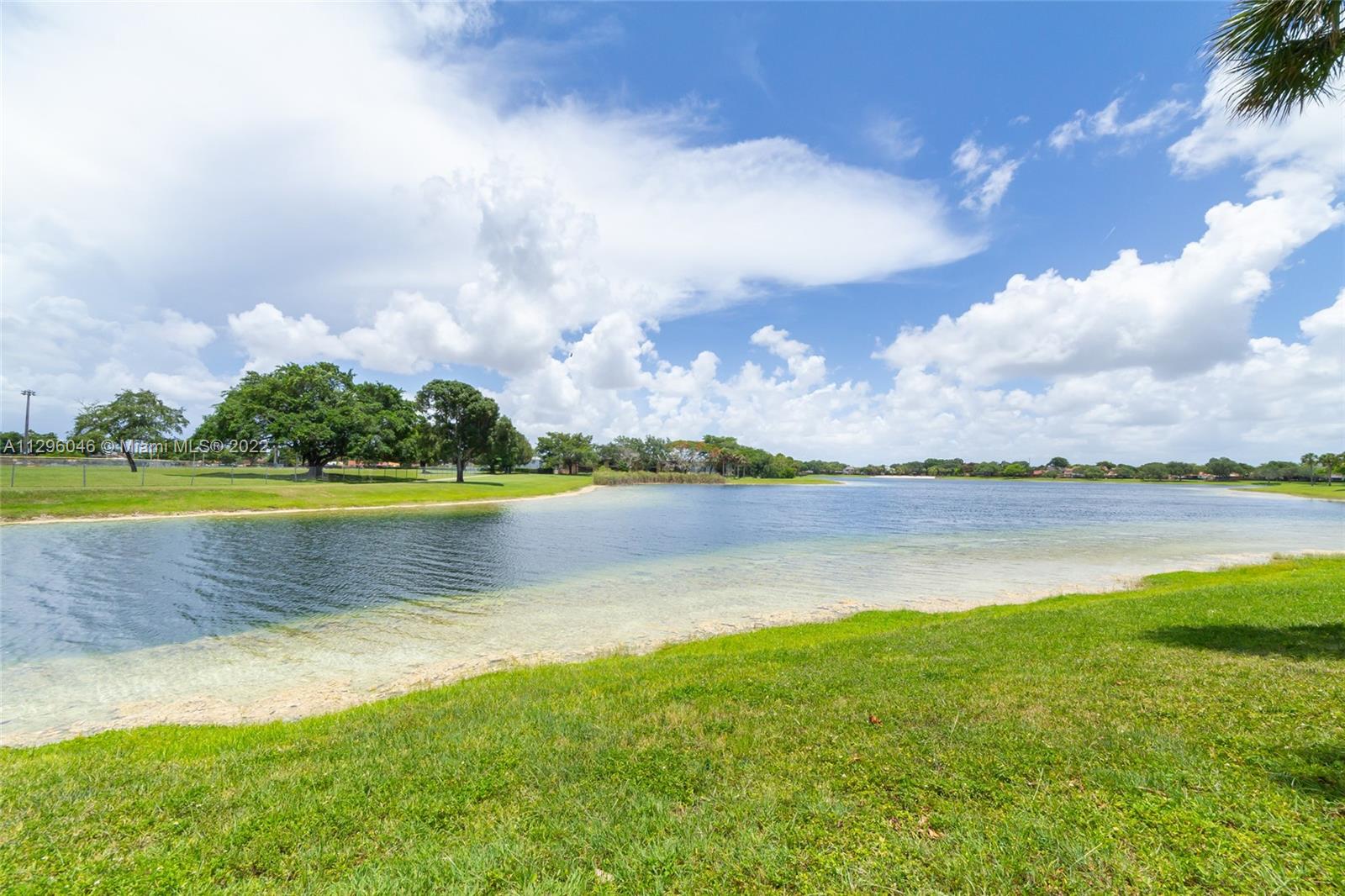 15070 Southwest 103rd Lane, Unit 2107 Miami, FL 33196 - Photo 3 of 5 a view of a lake with a big yard