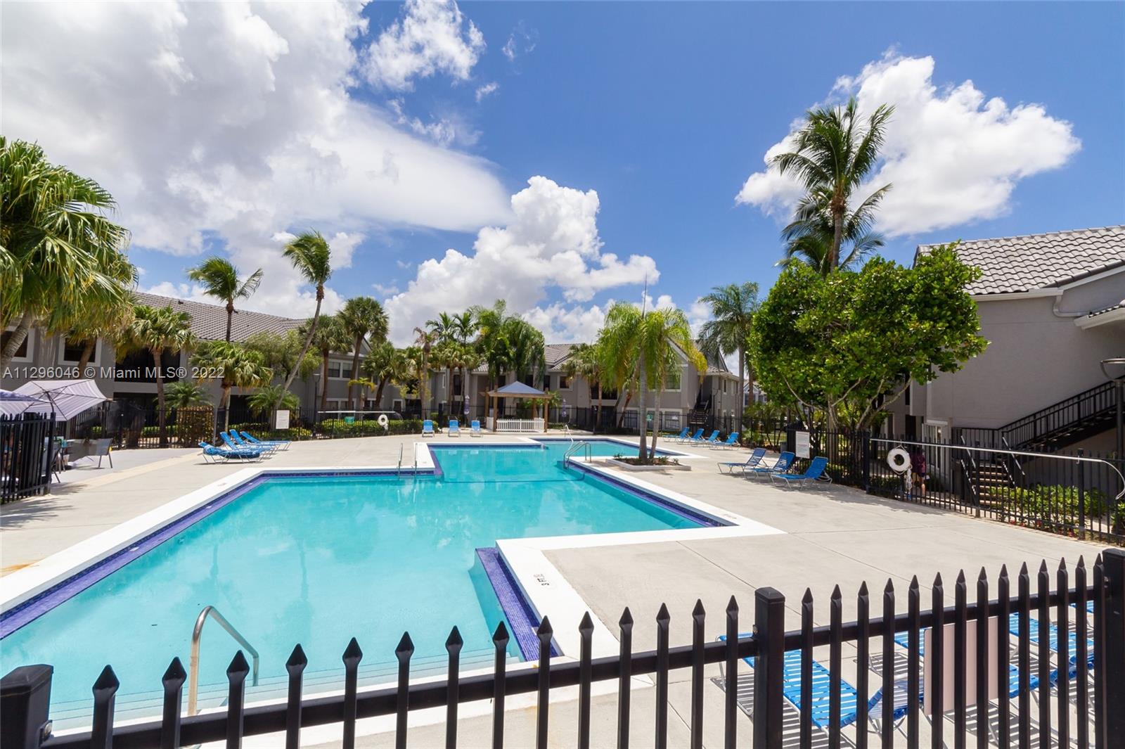15070 Southwest 103rd Lane, Unit 2107 Miami, FL 33196 - Photo 5 of 5 a swimming pool with outdoor seating and yard
