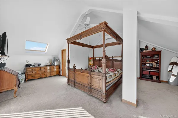 a bedroom with furniture and a window