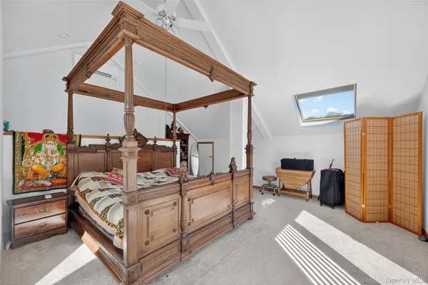 a bedroom with furniture and a window