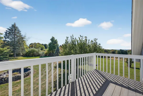 a view of a balcony with wooden floor