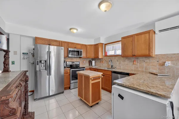 a kitchen with a sink a counter top space and stainless steel appliances