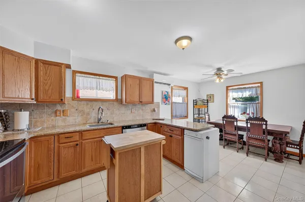 a kitchen that has a sink and chair