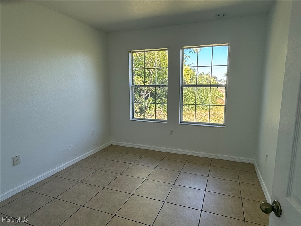 633 Alabama Road South, Unit 635 Lehigh Acres, FL 33974 - Photo 12 of 19 an empty room with windows
