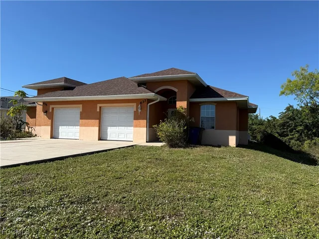 a front view of a house with a garden
