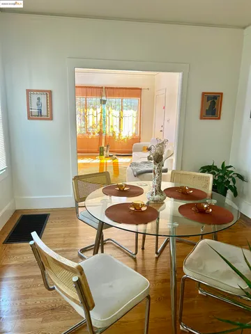 a dining room with furniture and wooden floor