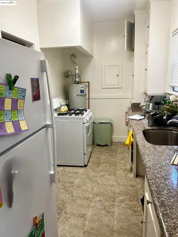 a kitchen with a sink a stove and wooden cabinets