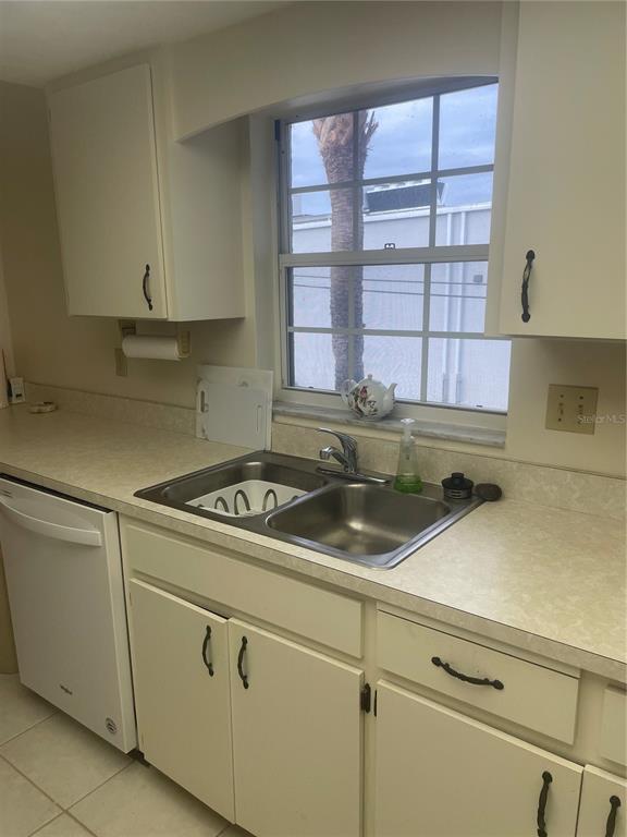 1531 Placida Road, Unit 201 Englewood, FL 34223 - Photo 13 of 25 a kitchen with a cabinets and window