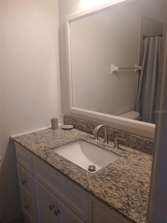 1531 Placida Road, Unit 201 Englewood, FL 34223 - Photo 19 of 25 a bathroom with a granite countertop sink and a mirror