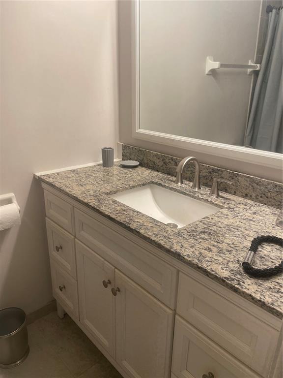 1531 Placida Road, Unit 201 Englewood, FL 34223 - Photo 20 of 25 a bathroom with a granite countertop sink and a mirror