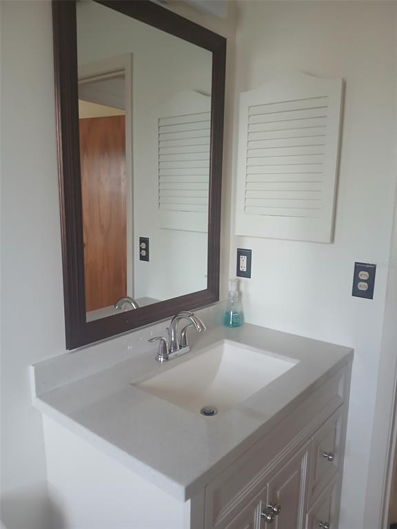 1531 Placida Road, Unit 201 Englewood, FL 34223 - Photo 23 of 25 a bathroom with a sink and a mirror
