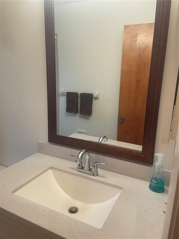 1531 Placida Road, Unit 201 Englewood, FL 34223 - Photo 24 of 25 a bathroom with a sink and a mirror