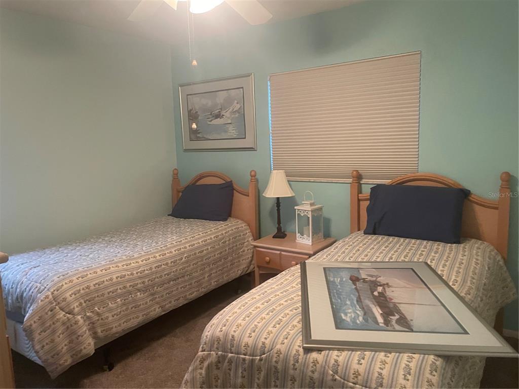 1531 Placida Road, Unit 201 Englewood, FL 34223 - Photo 25 of 25 a bedroom with two beds and painting on the wall
