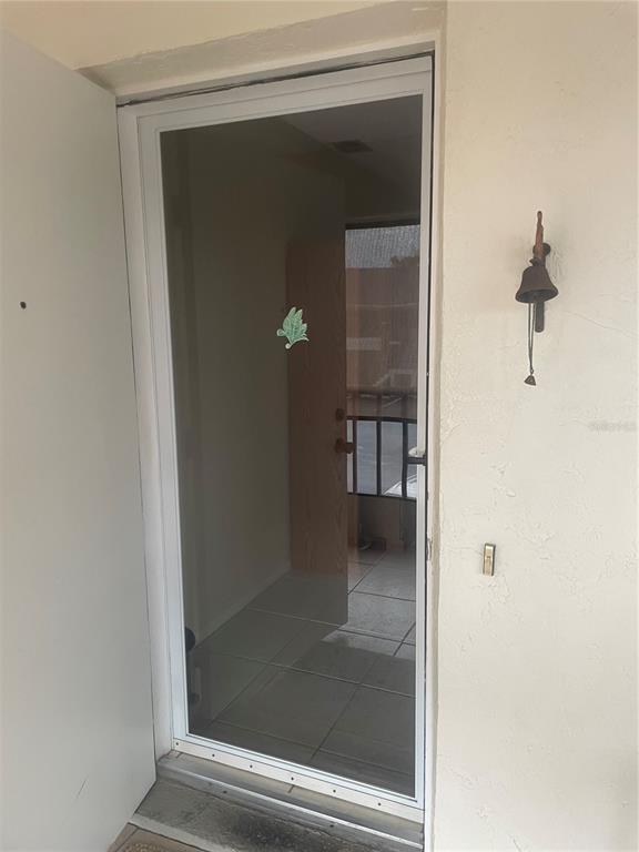 1531 Placida Road, Unit 201 Englewood, FL 34223 - Photo 6 of 25 a bathroom with a glass shower door and a sink