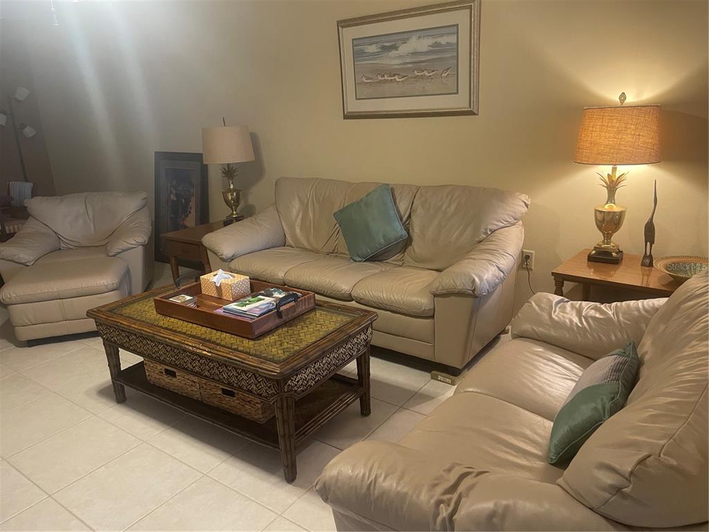 1531 Placida Road, Unit 201 Englewood, FL 34223 - Photo 8 of 25 a living room with furniture and a couch