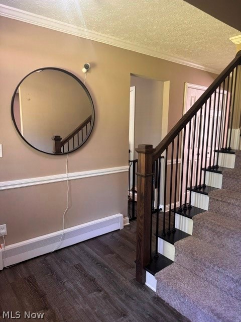 2760 Haines Road Madison, OH 44057 - Photo 6 of 33 Entryway featuring wood-finish flooring, a carpeted staircase with dark wood newel post, and black wrought iron balusters
