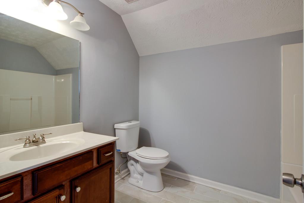 3280 Anderson Road Antioch, TN 37013 - Photo 15 of 30 a bathroom with a toilet a sink and a mirror