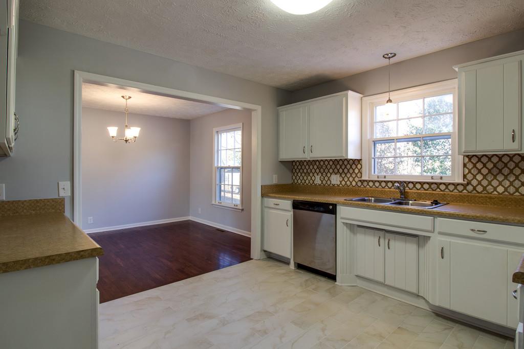 3280 Anderson Road Antioch, TN 37013 - Photo 8 of 30 a kitchen with granite countertop a stove a sink and a window