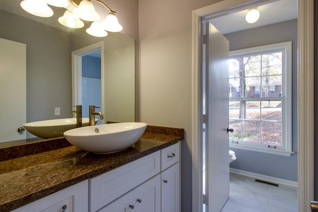3280 Anderson Road Antioch, TN 37013 - Photo 10 of 30 a bathroom with a granite countertop sink and a mirror