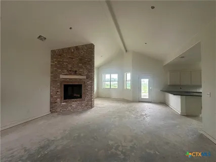 a view of a kitchen and window in a room