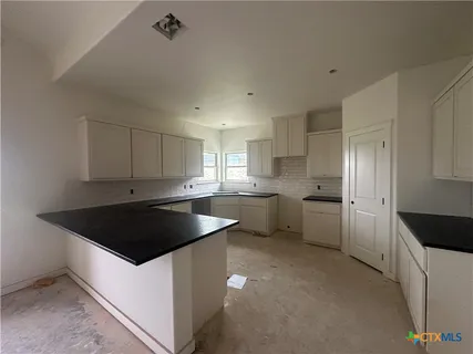 a kitchen with a white cabinets and white appliances