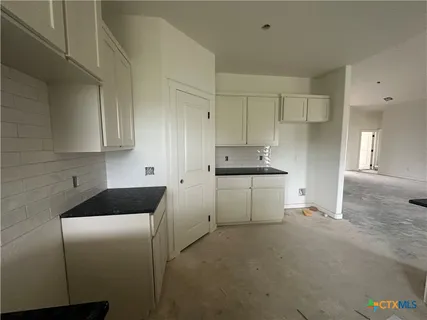 a kitchen with cabinets appliances and a sink