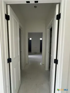 a view of an empty room with a closet
