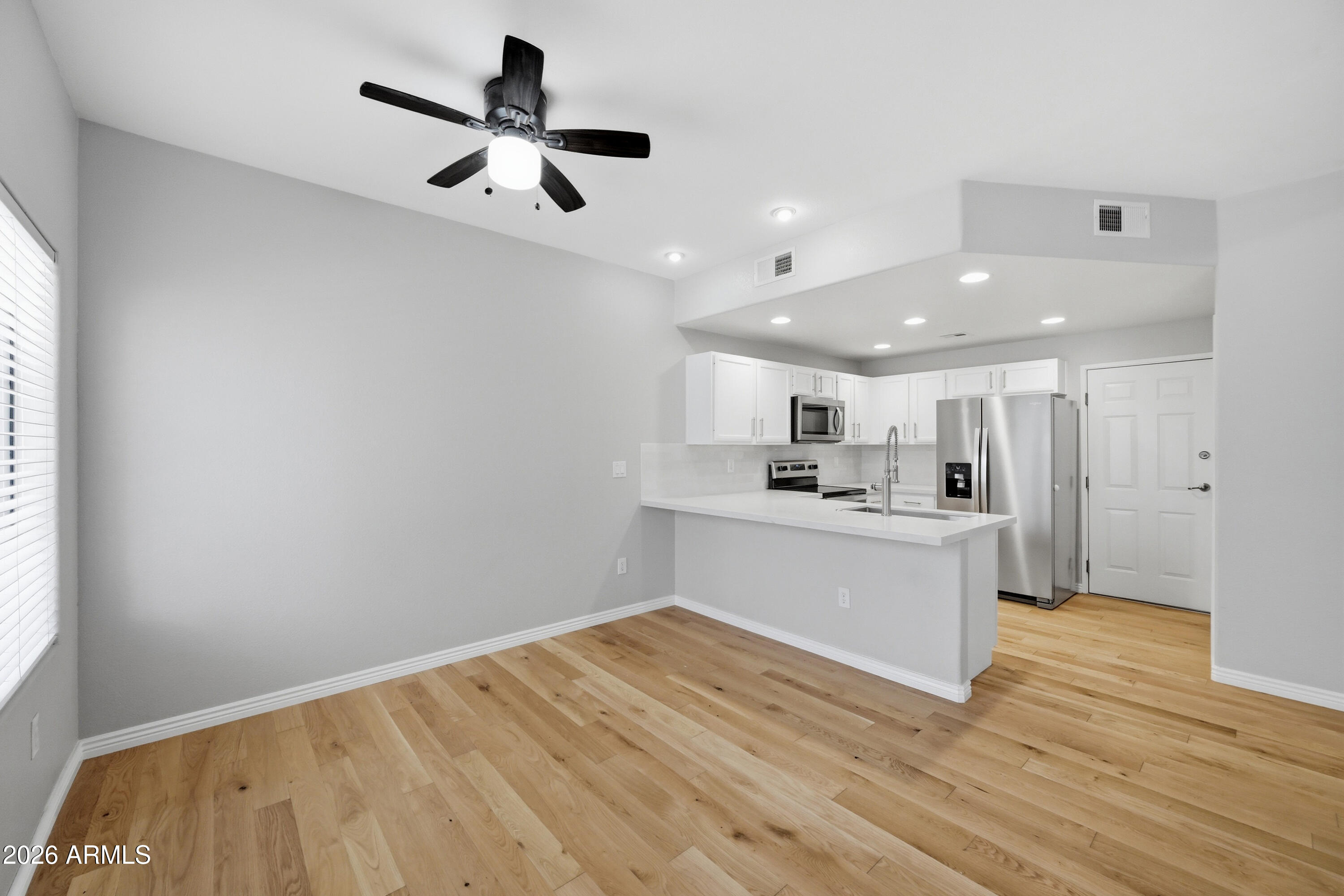 3150 East Beardsley Road, Unit 1009 Phoenix, AZ 85050 - Photo 9 of 31 a view of kitchen with wooden floor and window