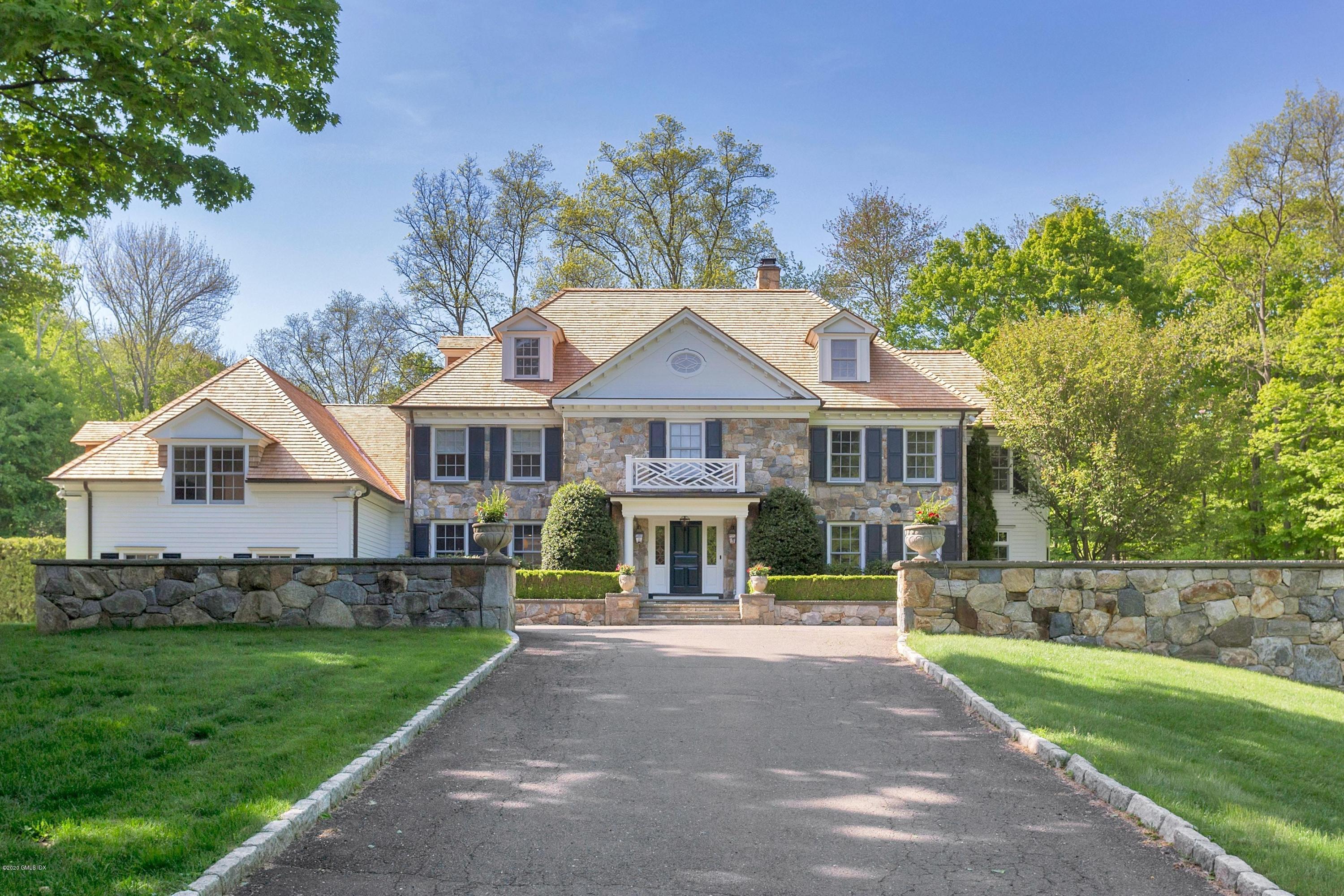 122 Butternut Hollow Road Greenwich, CT 06830 - Photo 1 of 36 a front view of a house with a garden