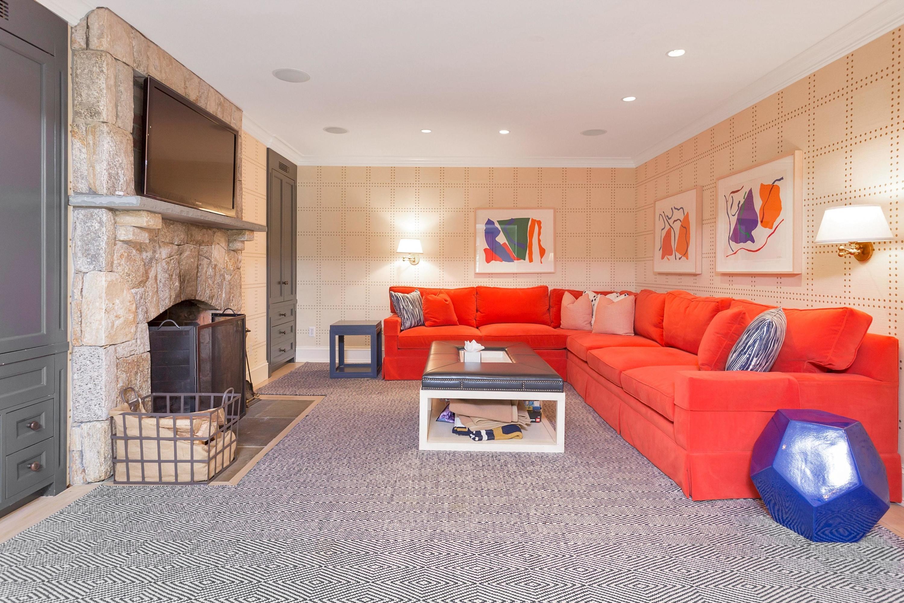 122 Butternut Hollow Road Greenwich, CT 06830 - Photo 11 of 36 a living room with a couch and a flat screen tv
